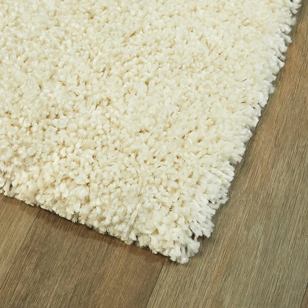 Beige shaggy rug on a wooden floor