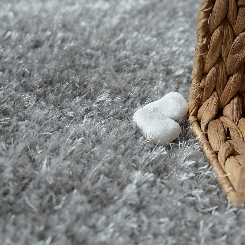 Gray carpet with woven basket and white stones