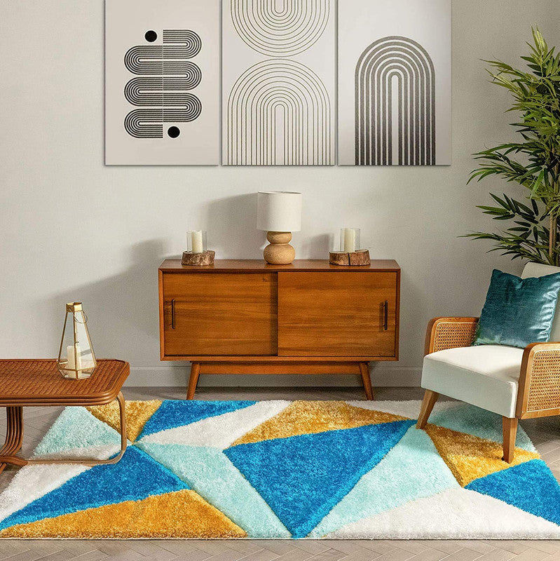 Living room with a geometric patterned rug, wooden cabinet, and decorative wall art.