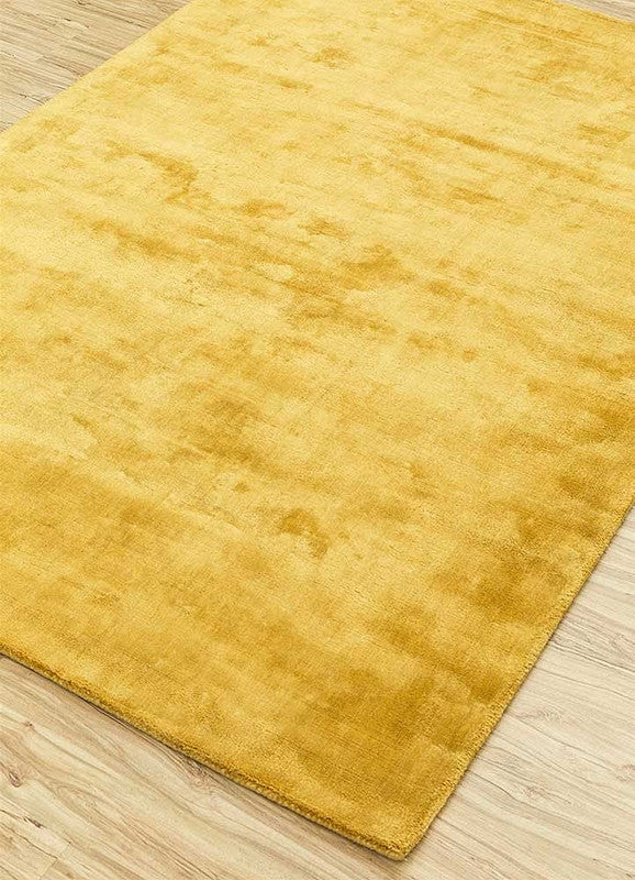 Yellow rug on a wooden floor
