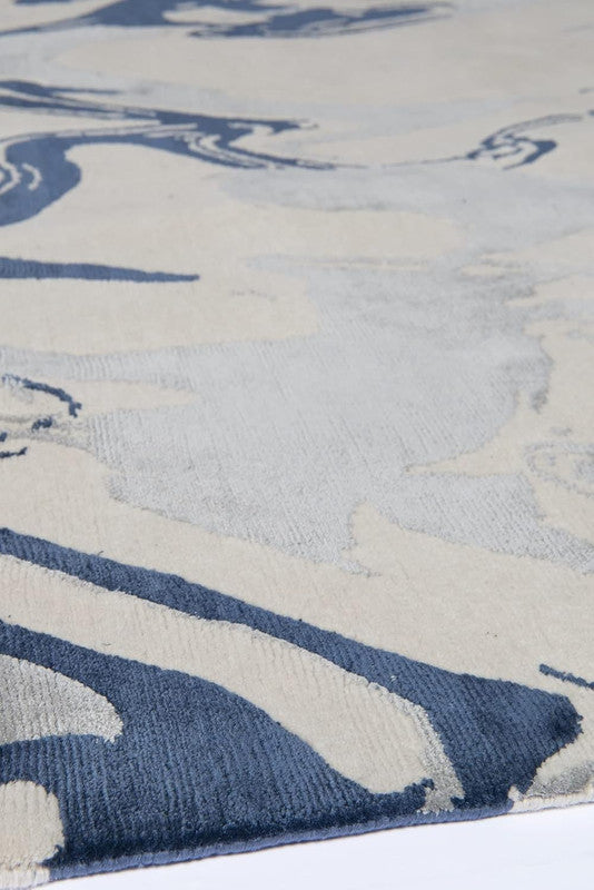 Close-up of a blue and beige patterned rug
