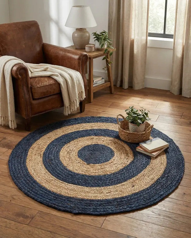 Round blue and beige braided rug in a living room with a brown armchair and wooden side table.