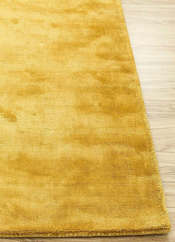 Yellow rug on a wooden floor