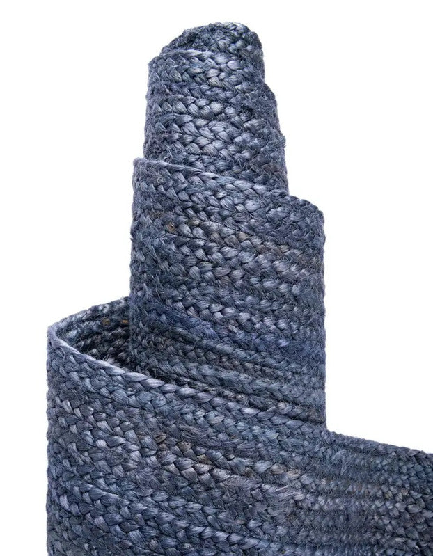 Close-up of a textured blue roll of carpet on a white background