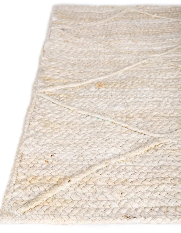 Beige woven rug with a geometric pattern on a white background