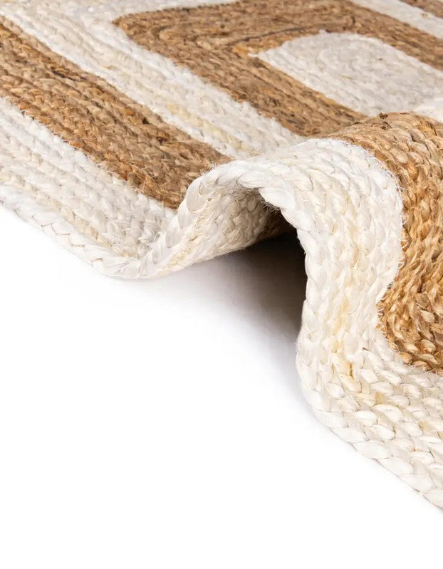 Close-up of a woven rug with beige and brown stripes on a white background
