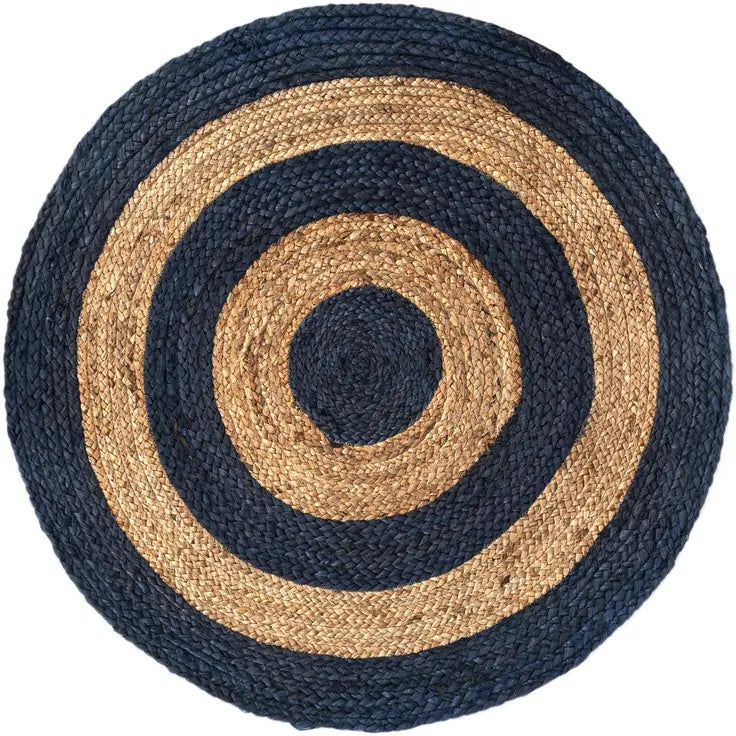 Round woven rug with concentric circle pattern in navy and beige on a white background