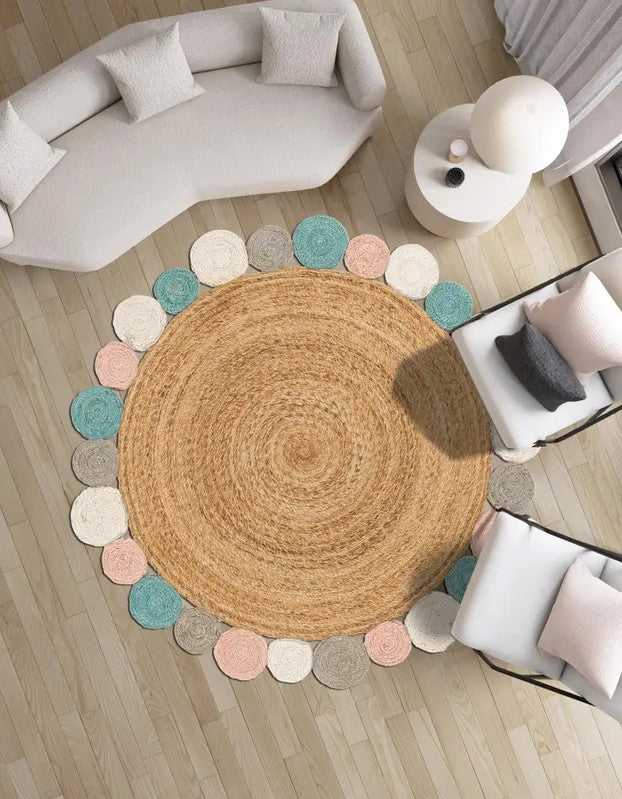 Round jute rug with multicolored circular accents in a living room setting.