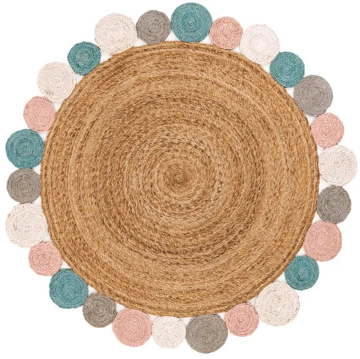 Round woven rug with colorful pom-pom border on a white background