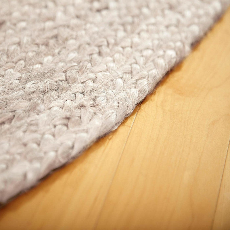 Gray textured rug on a wooden floor