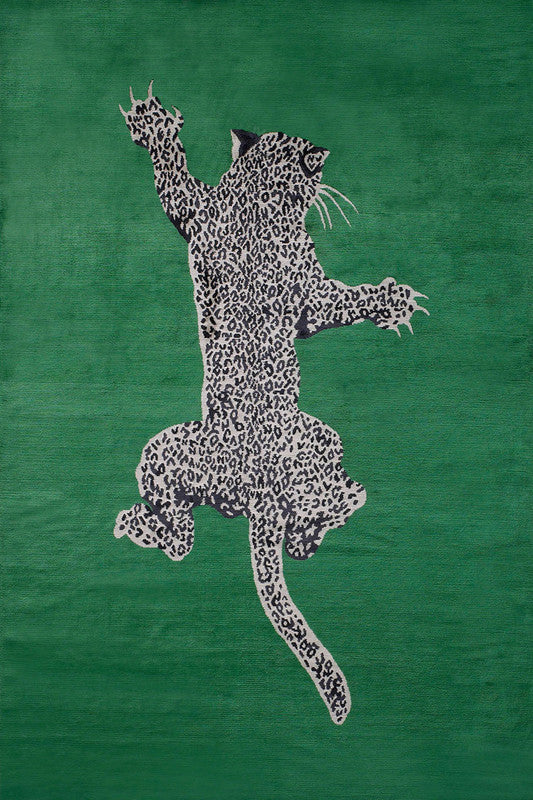 Leopard design on a green fabric background