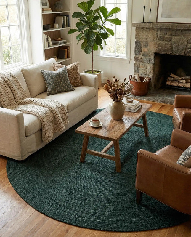 Living room with a beige sofa, brown armchair, wooden coffee table, and green rug.