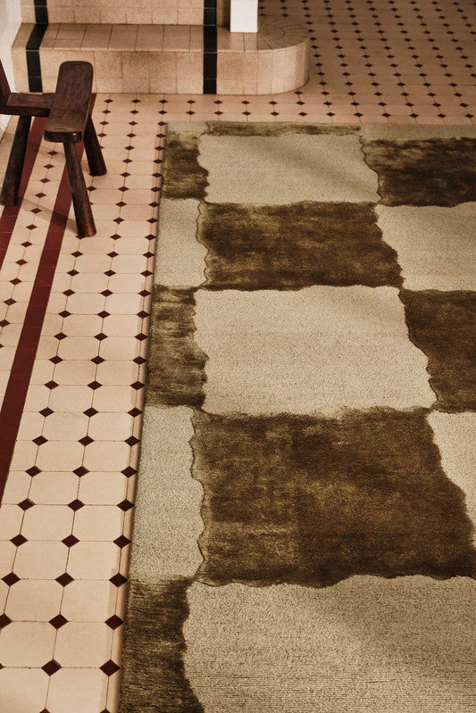 Textured rug with geometric pattern on a tiled floor