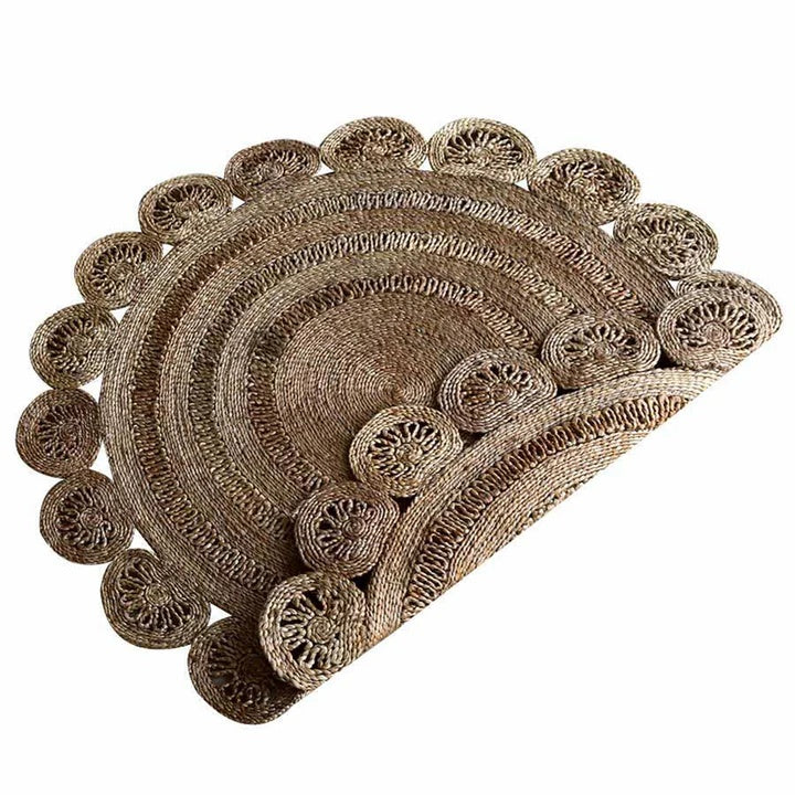 Set of round woven placemats with intricate designs on a white background