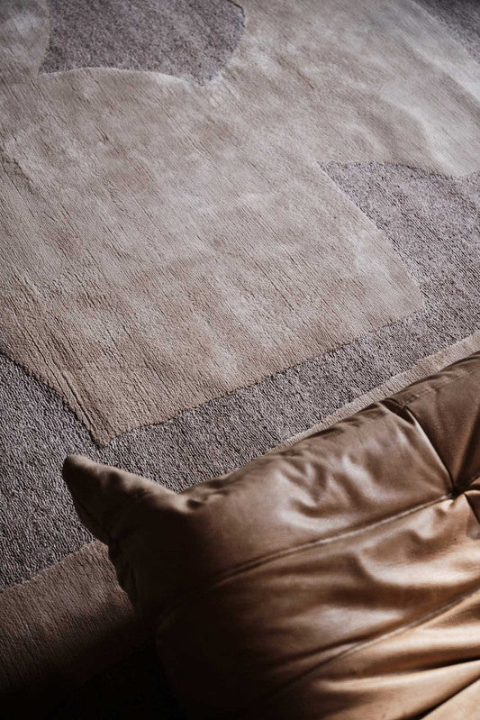 Brown leather sofa cushion on a textured brown rug