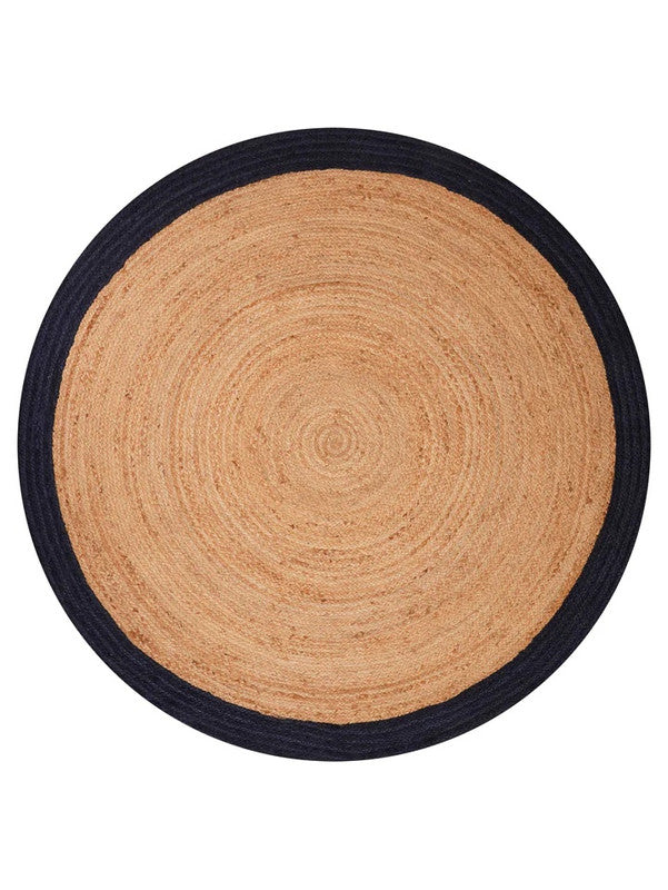 Round jute rug with black border on a white background