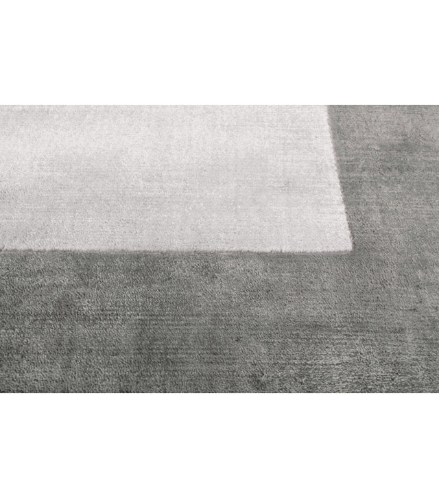Gray rug with a white border on a white background
