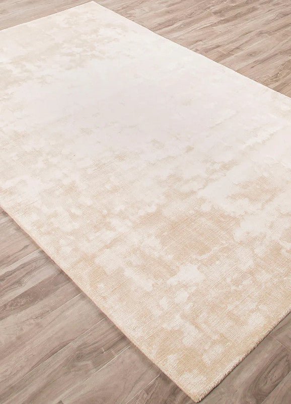 Beige area rug on a wooden floor