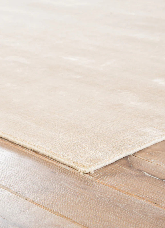 Beige rug on a wooden floor